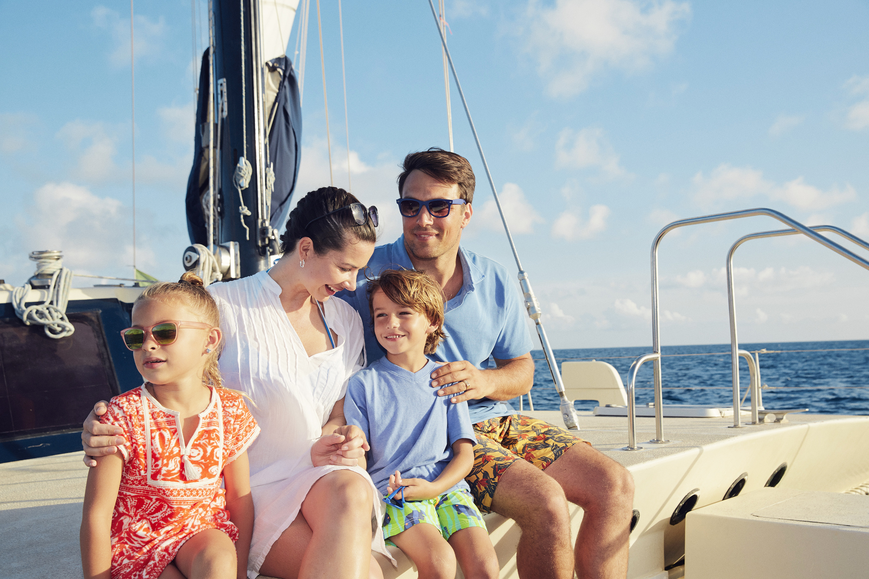 Family enjoying a sunny afternoon on a catamaran.