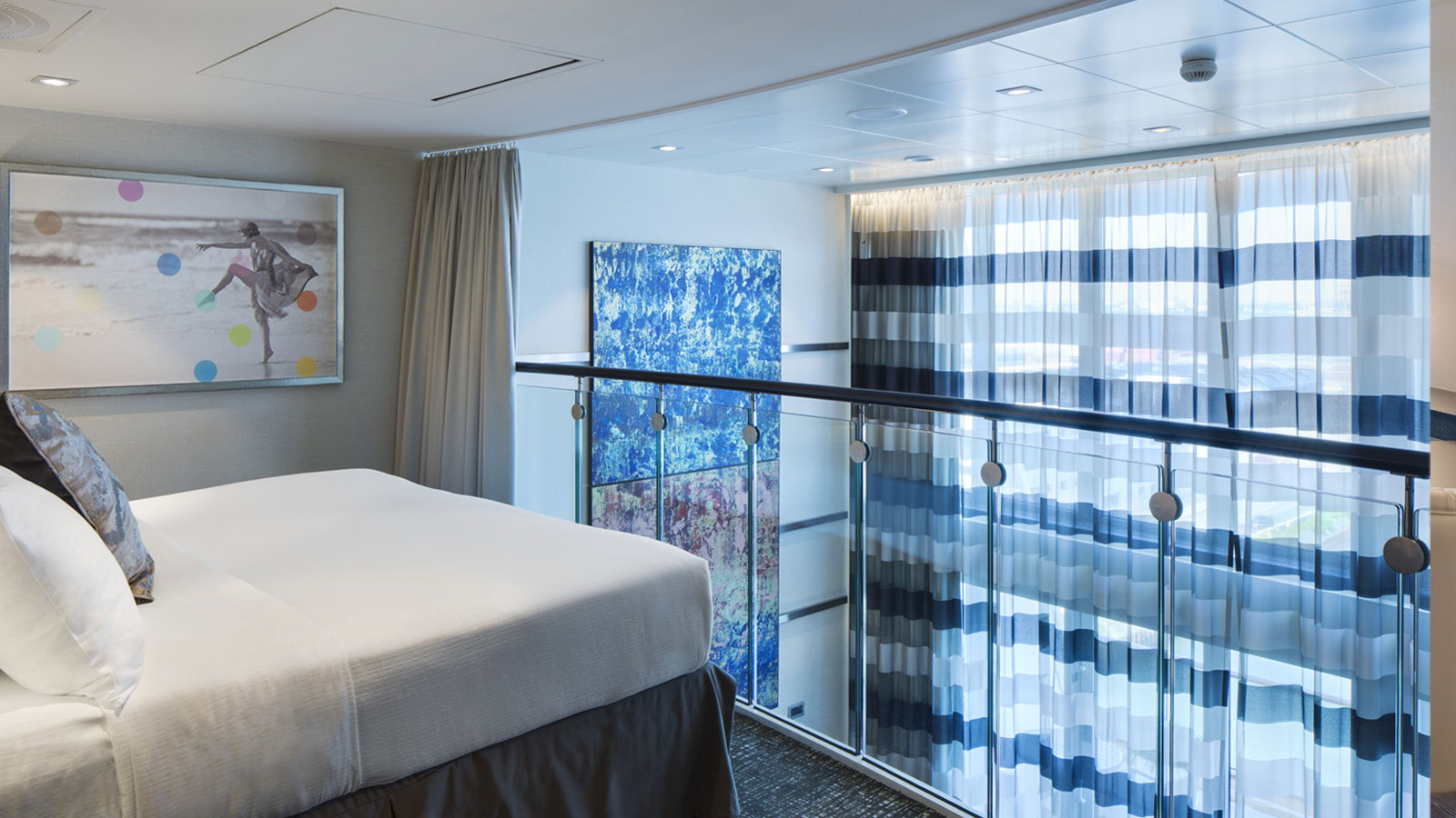 Primary bedroom on the second level loft overlooking the bottom level and pristine ocean views