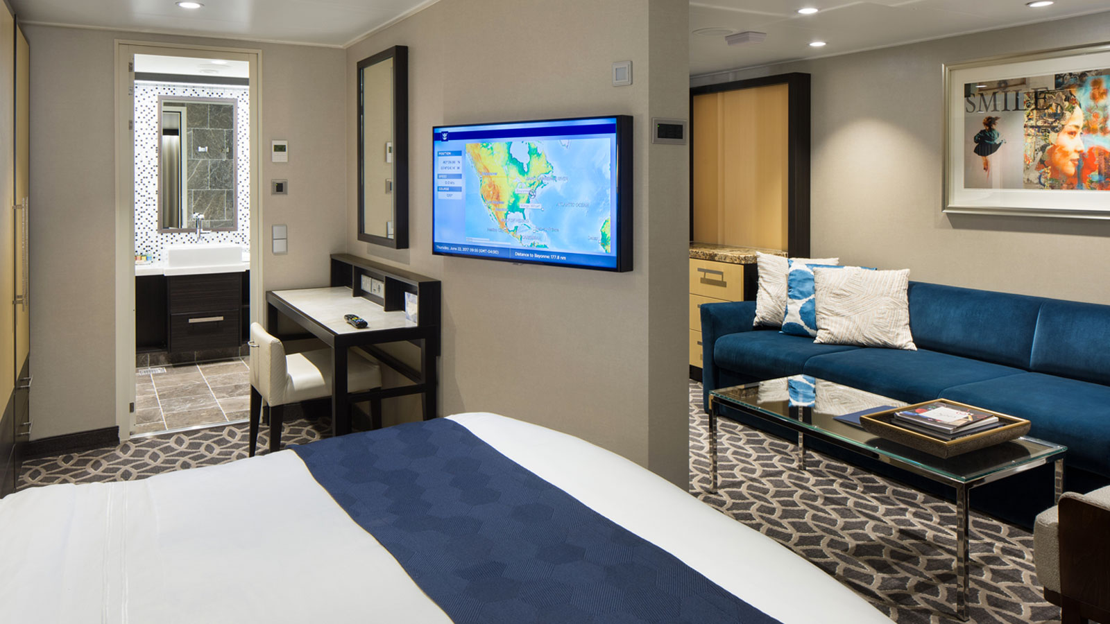 The Grand Suite's living room with bed and sitting area