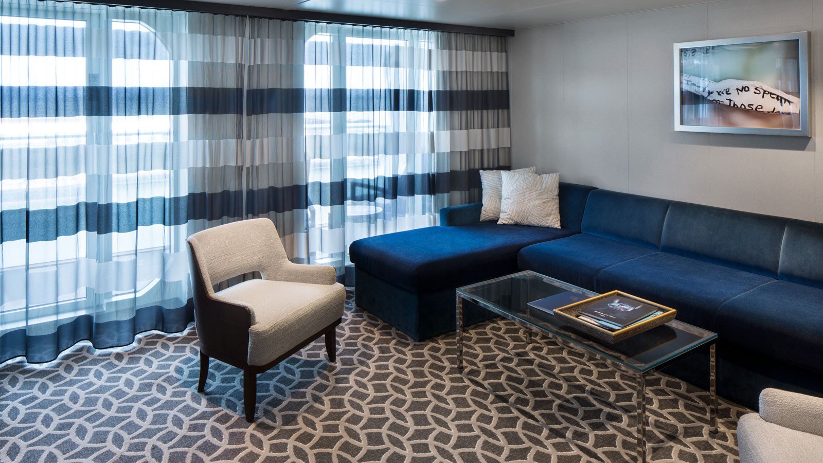 The Grand Suite's living room with bed and sitting area