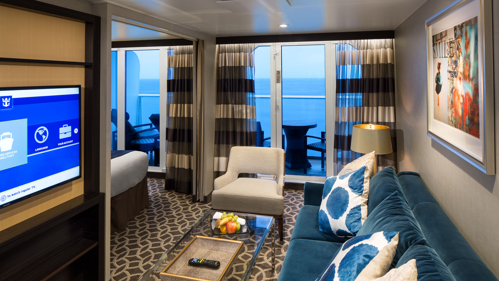 Main view of the Grand Suite with Large Balcony stateroom with vanity, sofa, bed, and private balcony