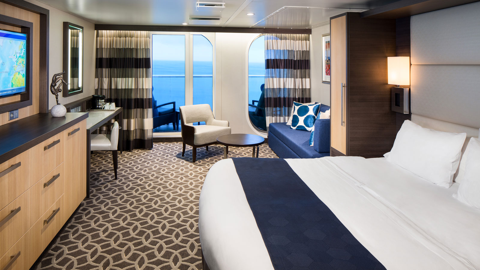 Main view of the Junior Suite with vanity, sofa, bed, and balcony