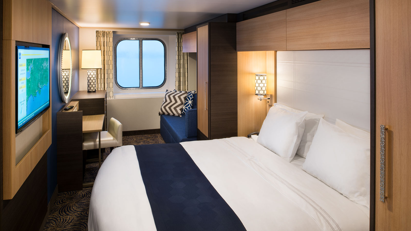 Main view of the Ocean View stateroom with vanity, sofa, bed, and balcony