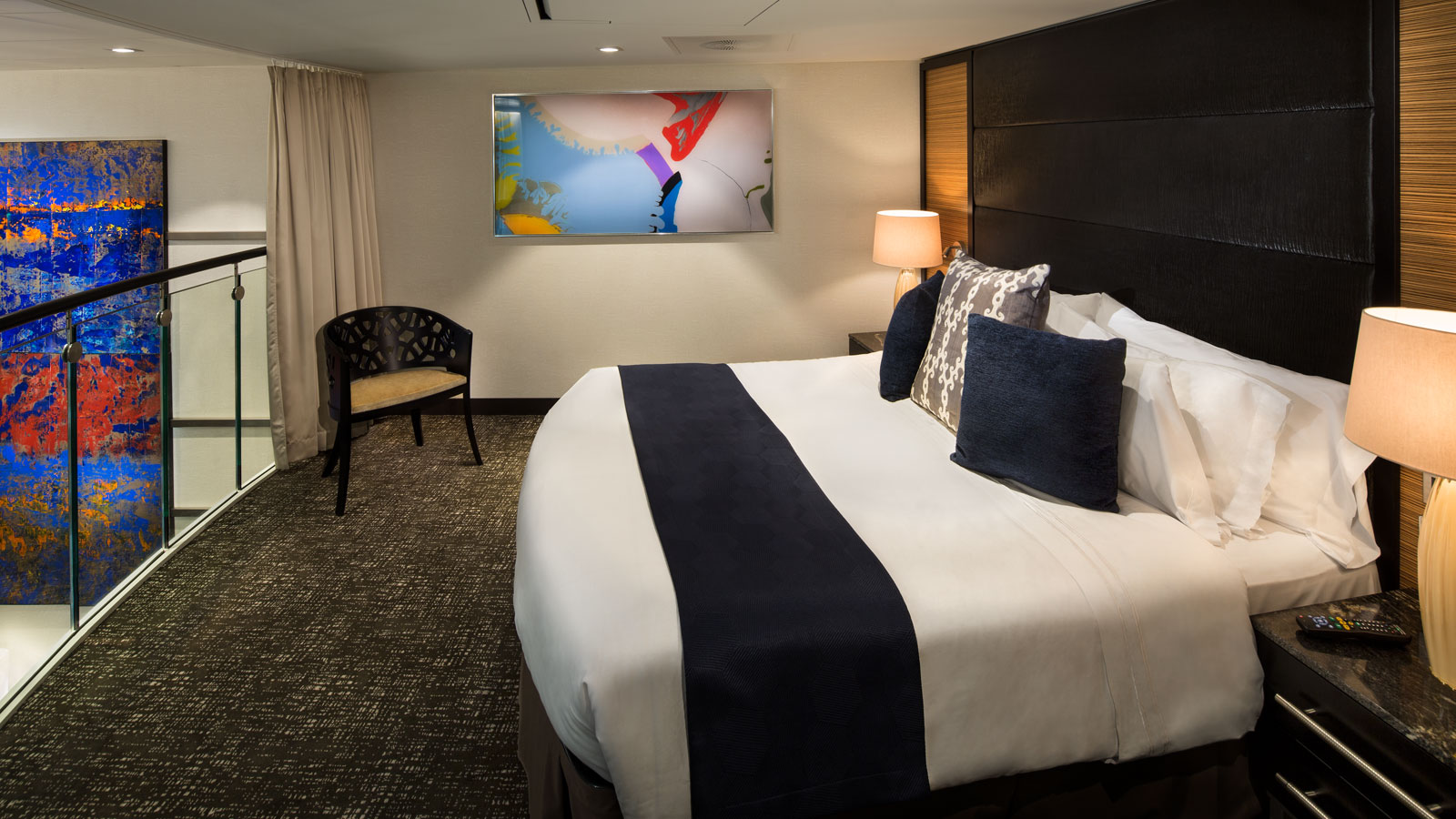 Primary bedroom on the second level loft overlooking the bottom level and pristine ocean views