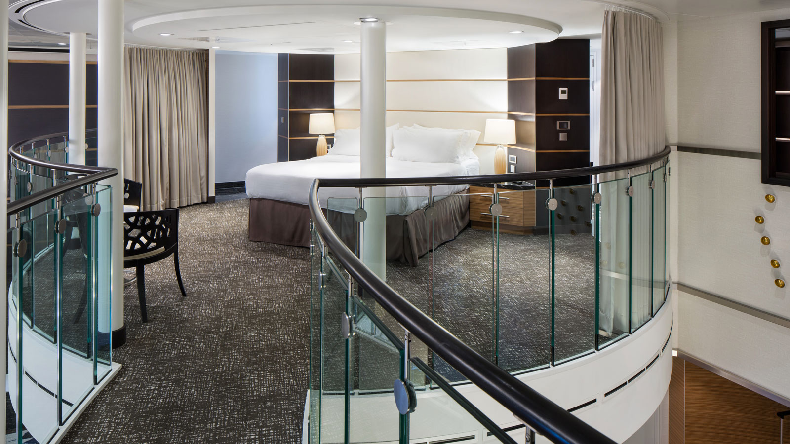 Primary bedroom on the second level loft overlooking the bottom level and pristine ocean views