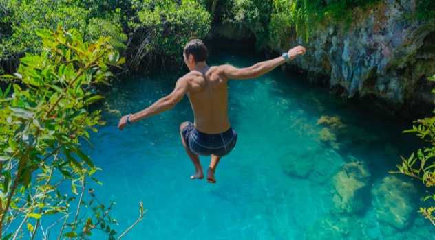Man jumping into cenote in Mexico