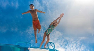 Kids jumping in Cozumel on a summer cruise