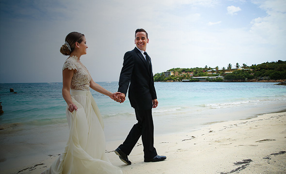 A couple walking on the beach during a destination wedding in the Bahamas.