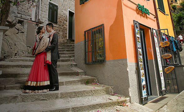 A couple standing on stairs during a romantic destination wedding.