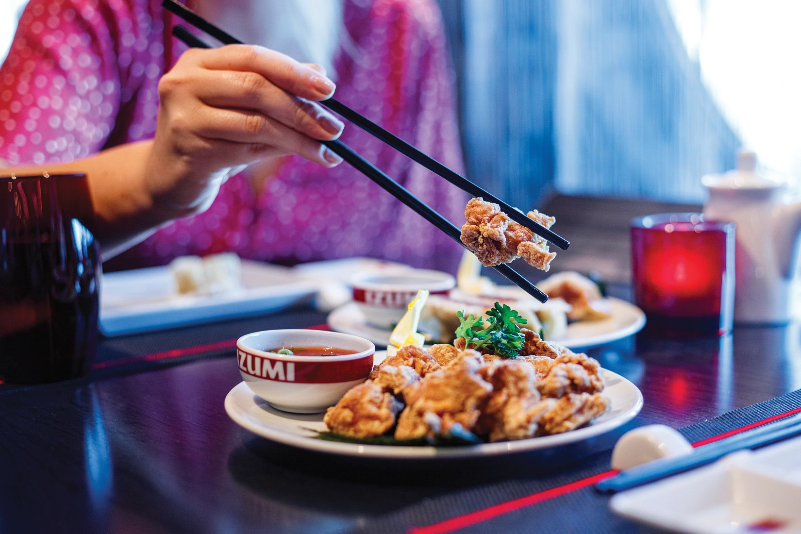 Izumi restaurant, hand holding chop sticks with piece of tempura, appetizer, SY, Symphony of the Seas, asian cooking, Japanese cuisine, dipping sauce