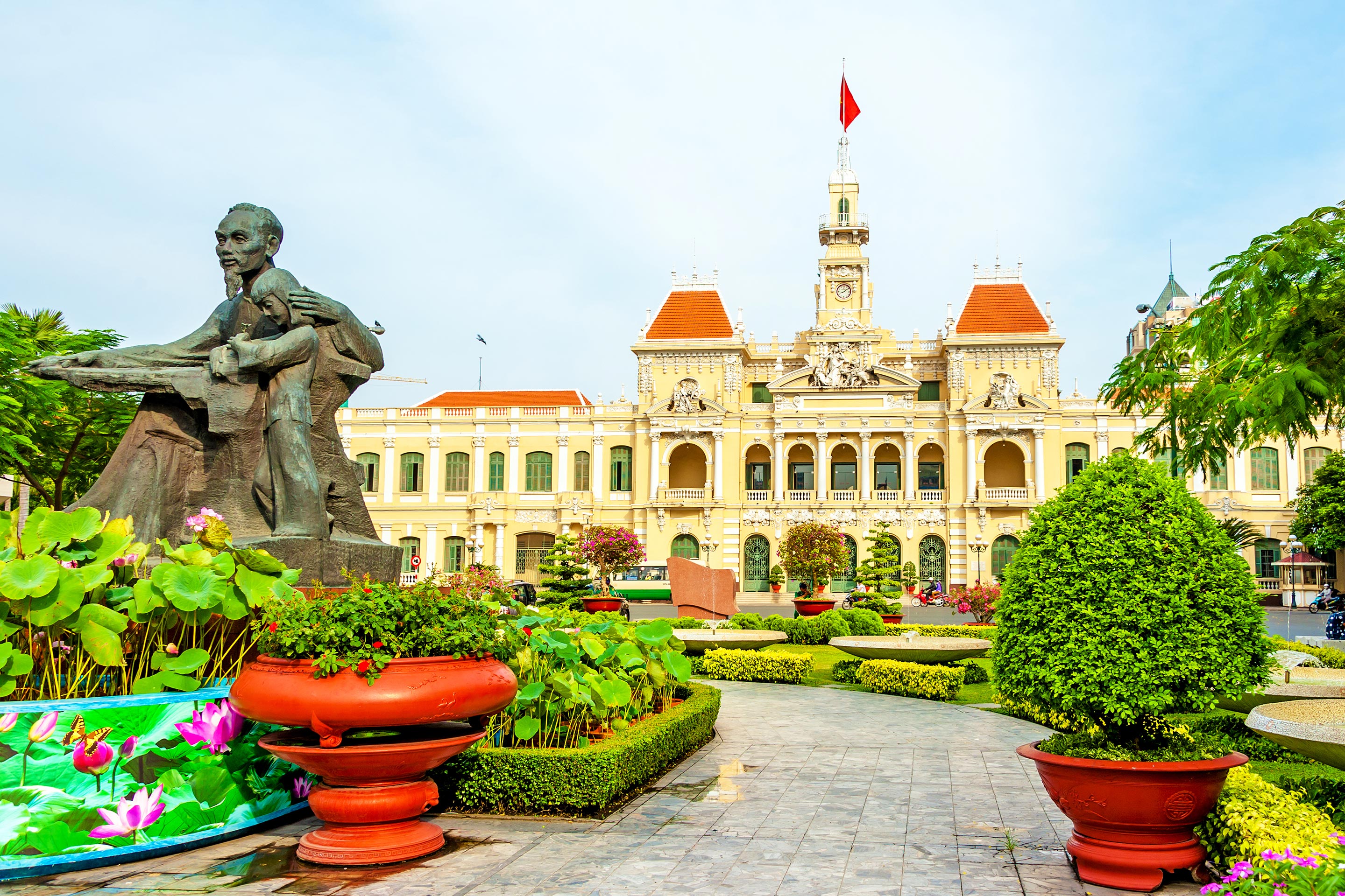 City hall with a garden and statue at the entrance of Ho Chi Minh, Vietnam