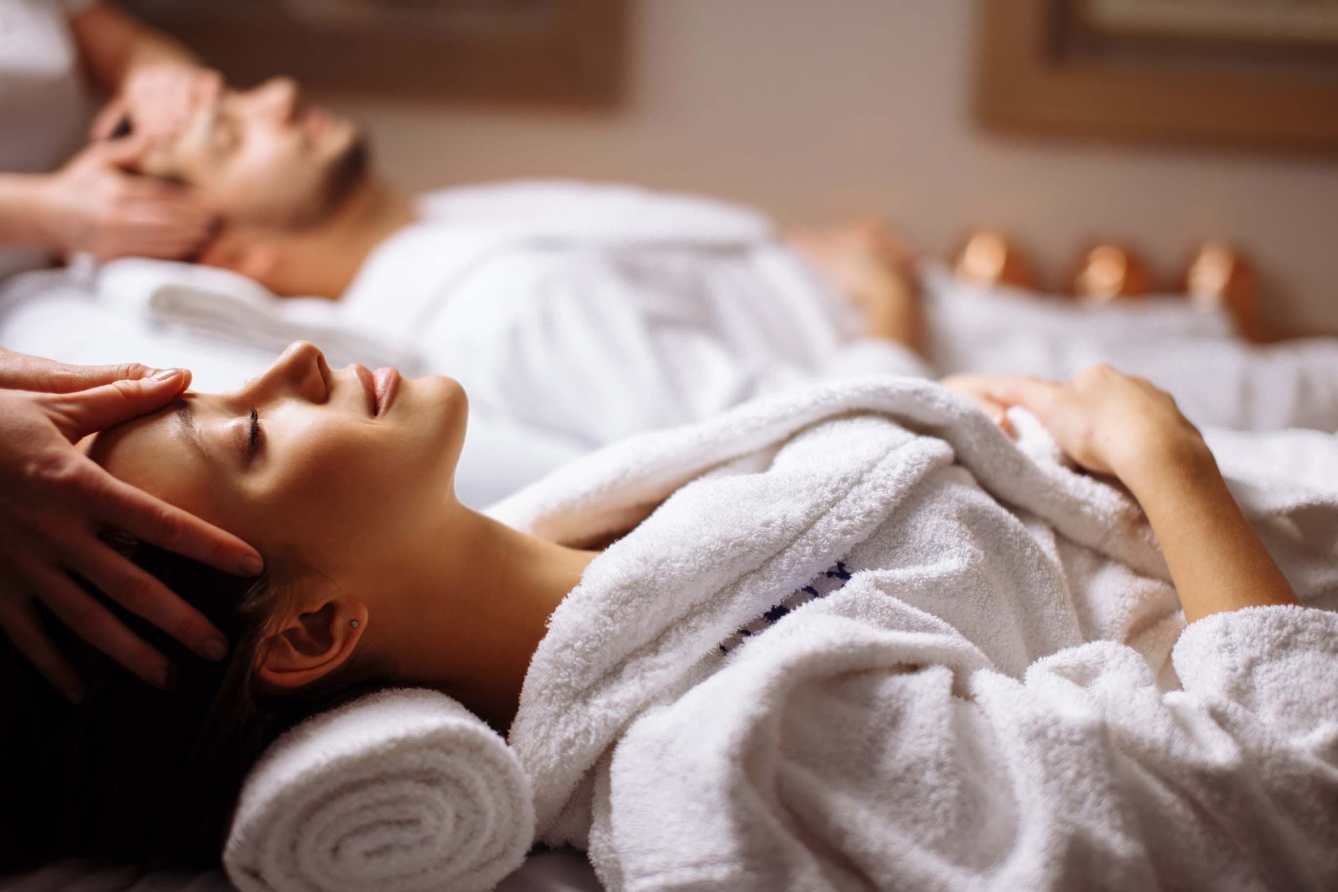 Two people receiving a back massage