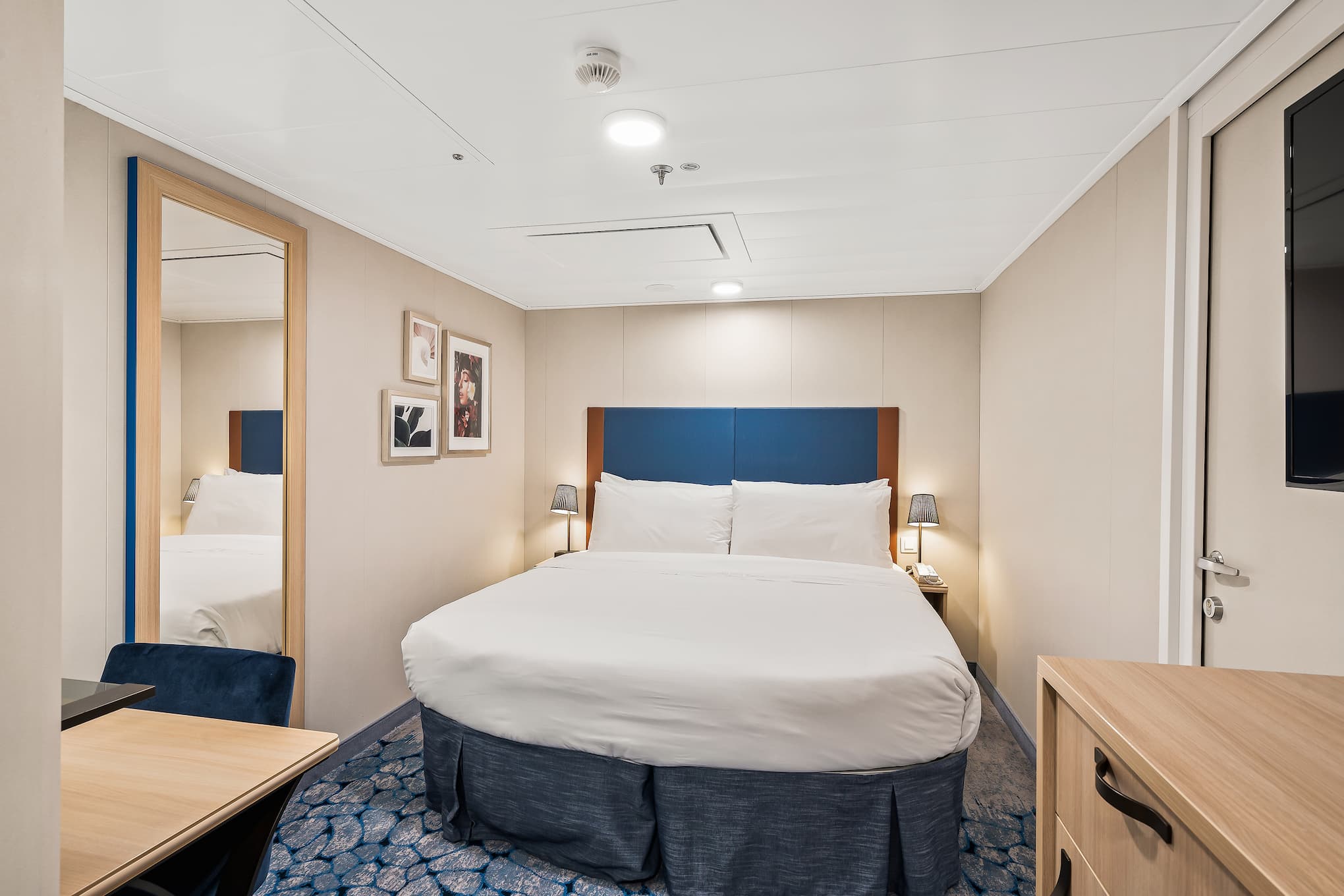 Bed in room on Utopia of the Seas