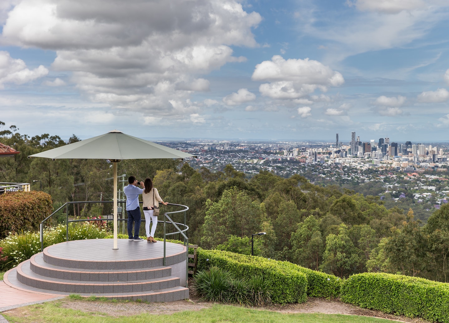 Couple takes photo at Mount Coot-tha Lookout. - Brisbane, Australia