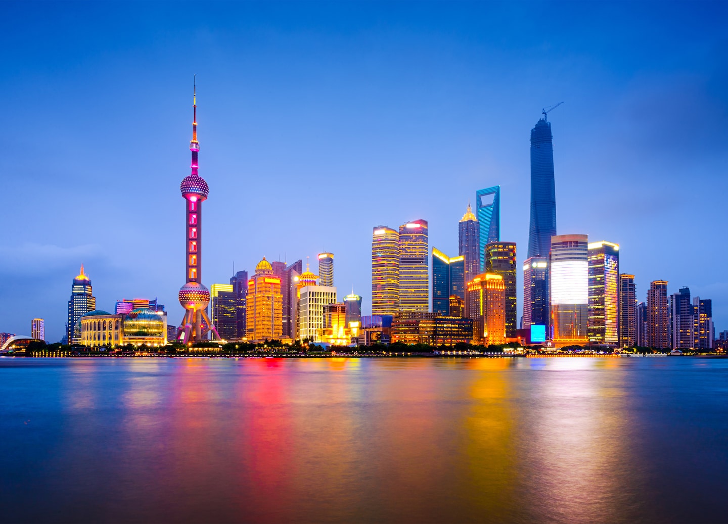 The Bund skyline reflects on the Huangpu River, blending history with modern rise. - Shanghai, China