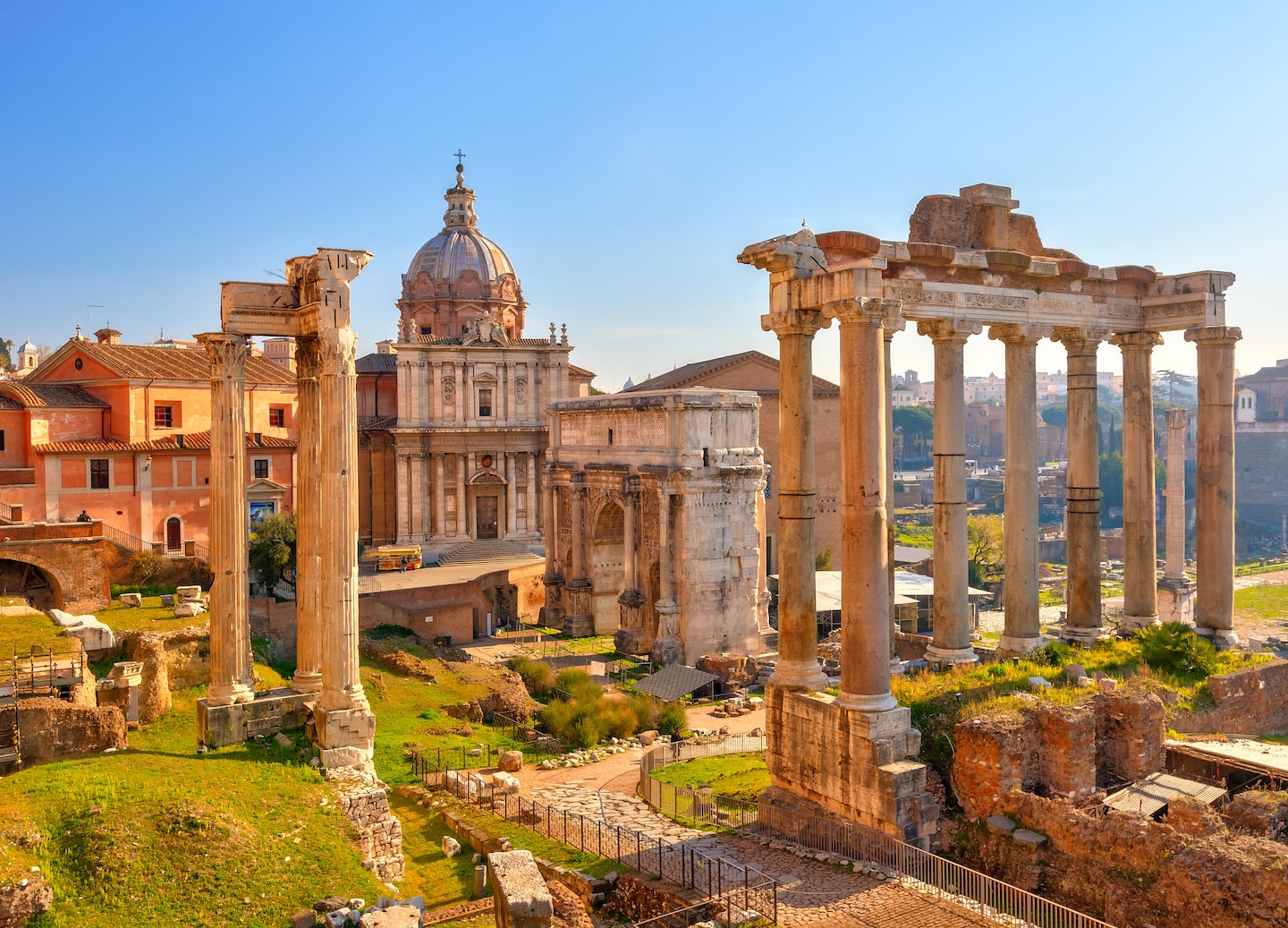 Ancient Roman Forum ruins stand beneath the sunlight. - Rome, Italy