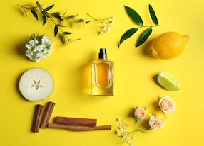 beautiful composition with bottle of generic fragrence perfume fruits and flowers on color background flat lay