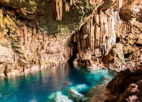 beautiful natural pool crystal clear water rocky cave with stalagmites