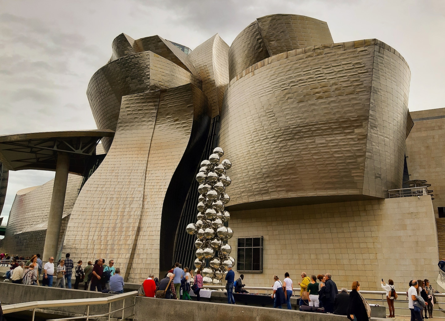 The Guggenheim Bilbao’s curved titanium exterior reflects light in a striking, sculptural form. - Bilbao, Spain