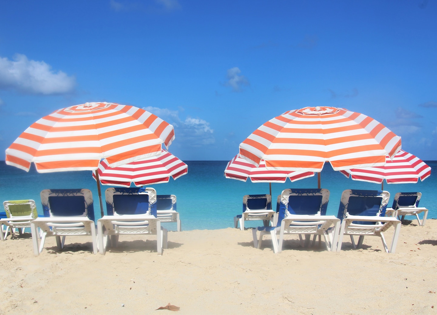 Relax at Mullet Bay Beach, enjoying white sand, palms, sunshine, and optional water activities. - Philipsburg, St. Maarten