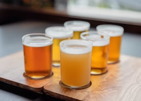 sampling variety of craft beers from a beer flight at a microbrewery