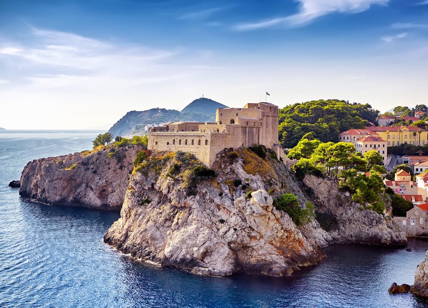 Dubrovnik’s Lovrijenac and Bokar fortresses rise above rocky cliffs, framed by the city’s old walls. - Dubrovnik, Croatia