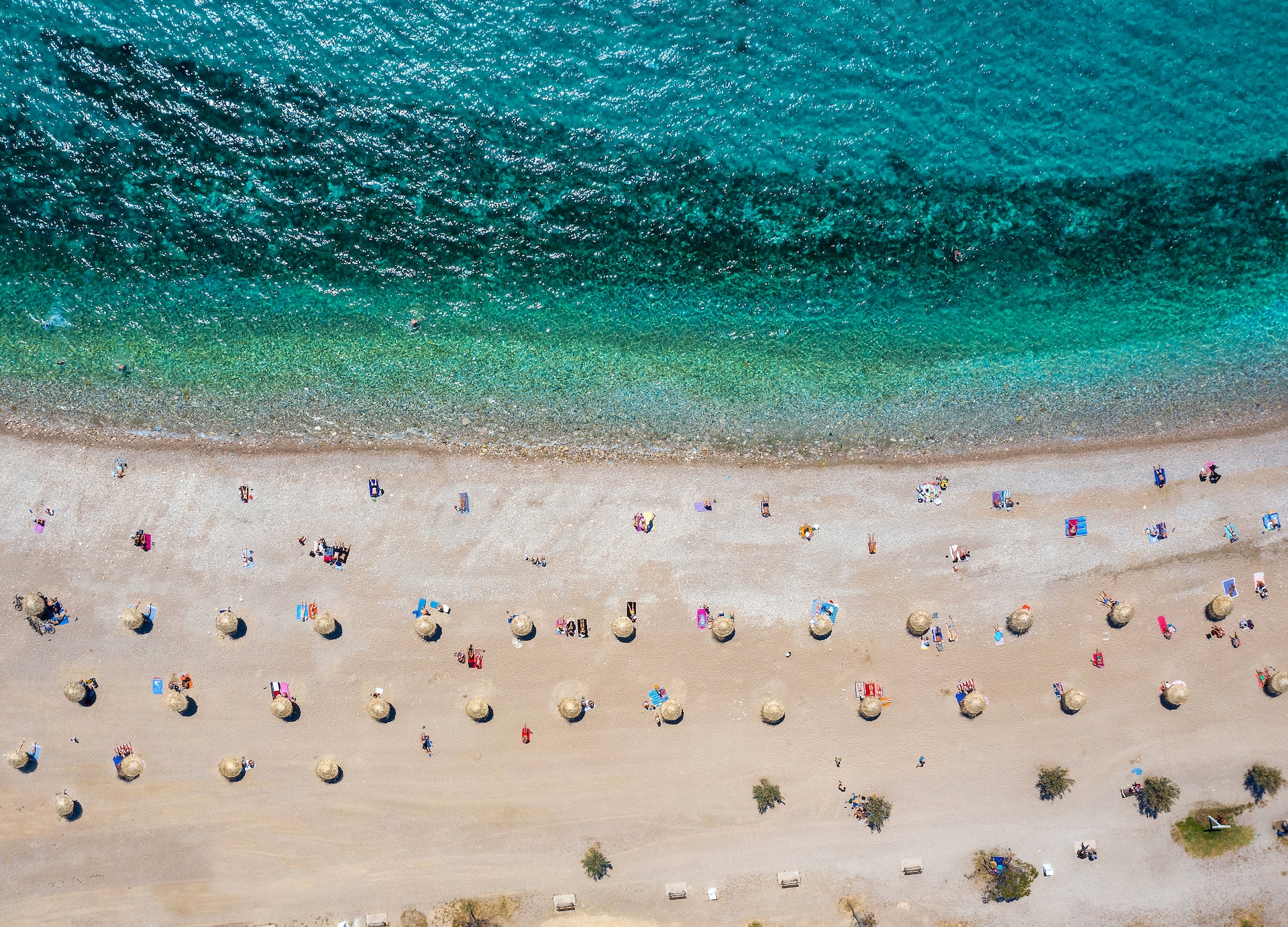 aerial top down view to the beach of glyfada district south athens riviera greece with umbrellas