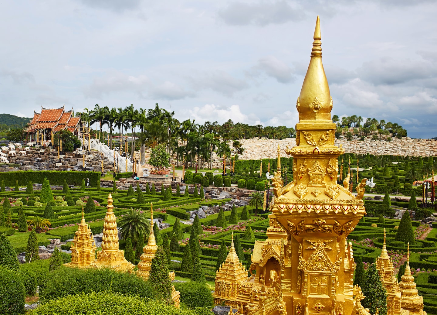 Nong Nooch Garden’s patterned hedges and golden statues create a vibrant, geometric landscape in Pattaya. - Bangkok (Laemchabang), Thailand