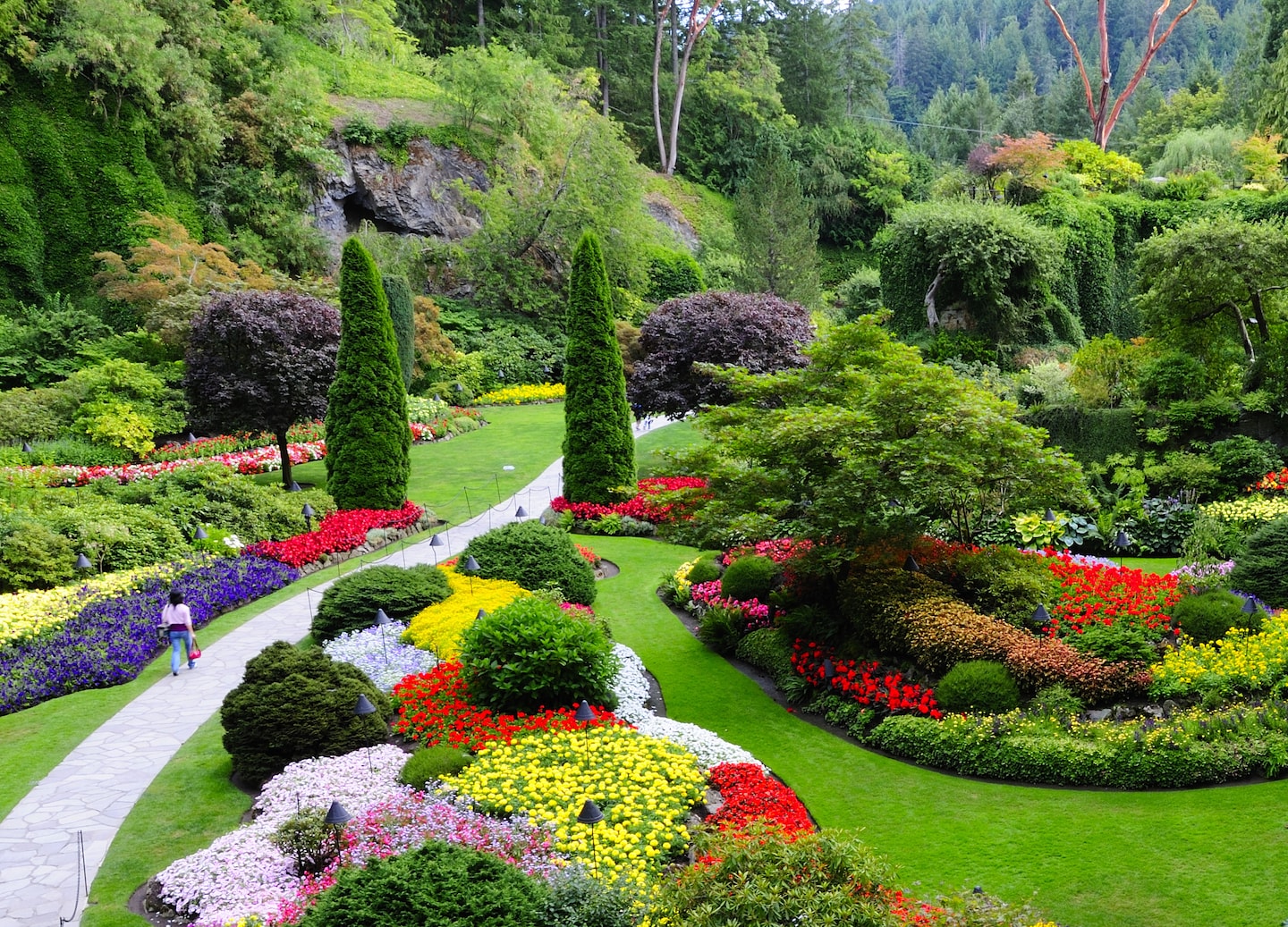 Sunken Garden in Butchart Garden with vibrant flowers, layered terraces, and lush greener. - Victoria, British Columbia