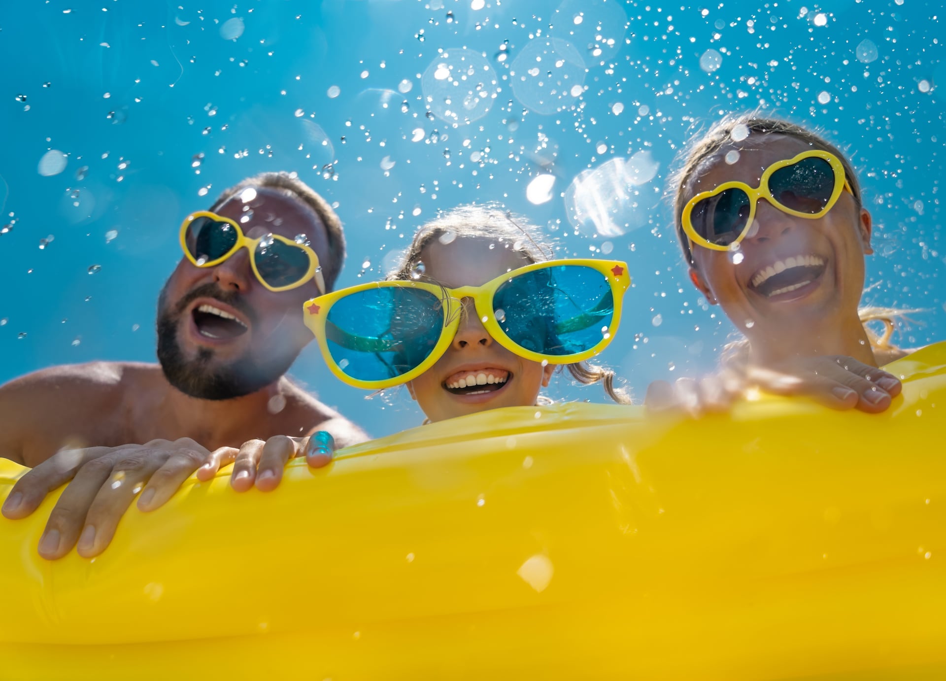 family having fun on summer vacation people jumping in swimming pool active lifestyle concept