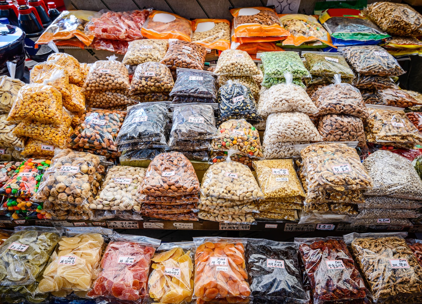 Colorful dried fruits and nuts fill Gwangjang Market trays, showcasing Seoul’s flavors. - Seoul, South Korea