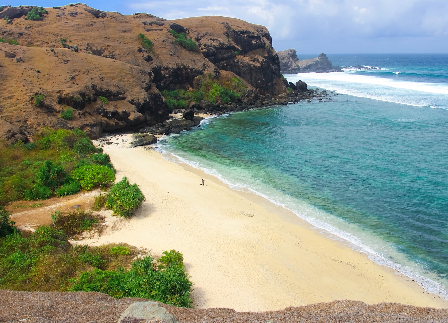 Coastal hills overlooking turquoise water and Mandalika shoreline.