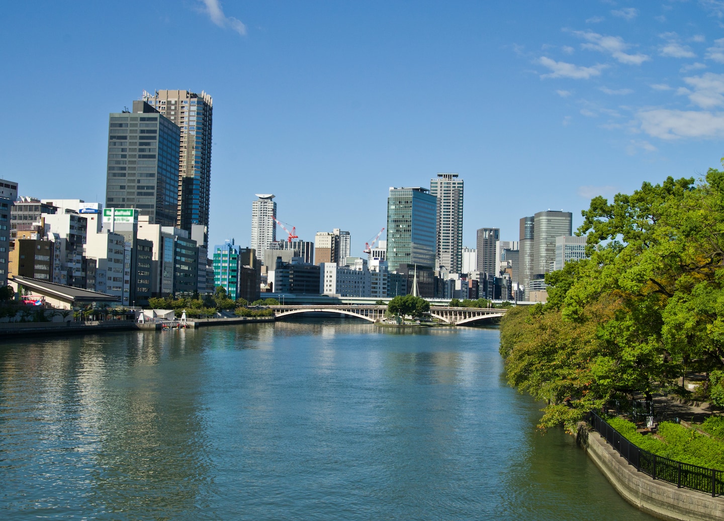 Osaka river cruise reveals modern towers and historic bridges.
