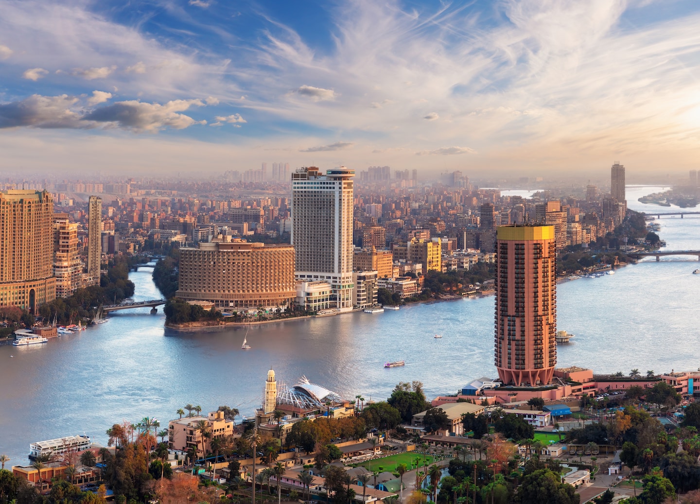 Cairo’s skyline rises along the Nile, with modern towers reflecting in the river’s calm water. - Cairo, Egypt