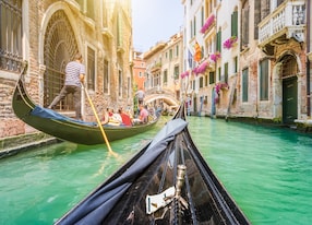 traditional gondolas on narrow canal venice