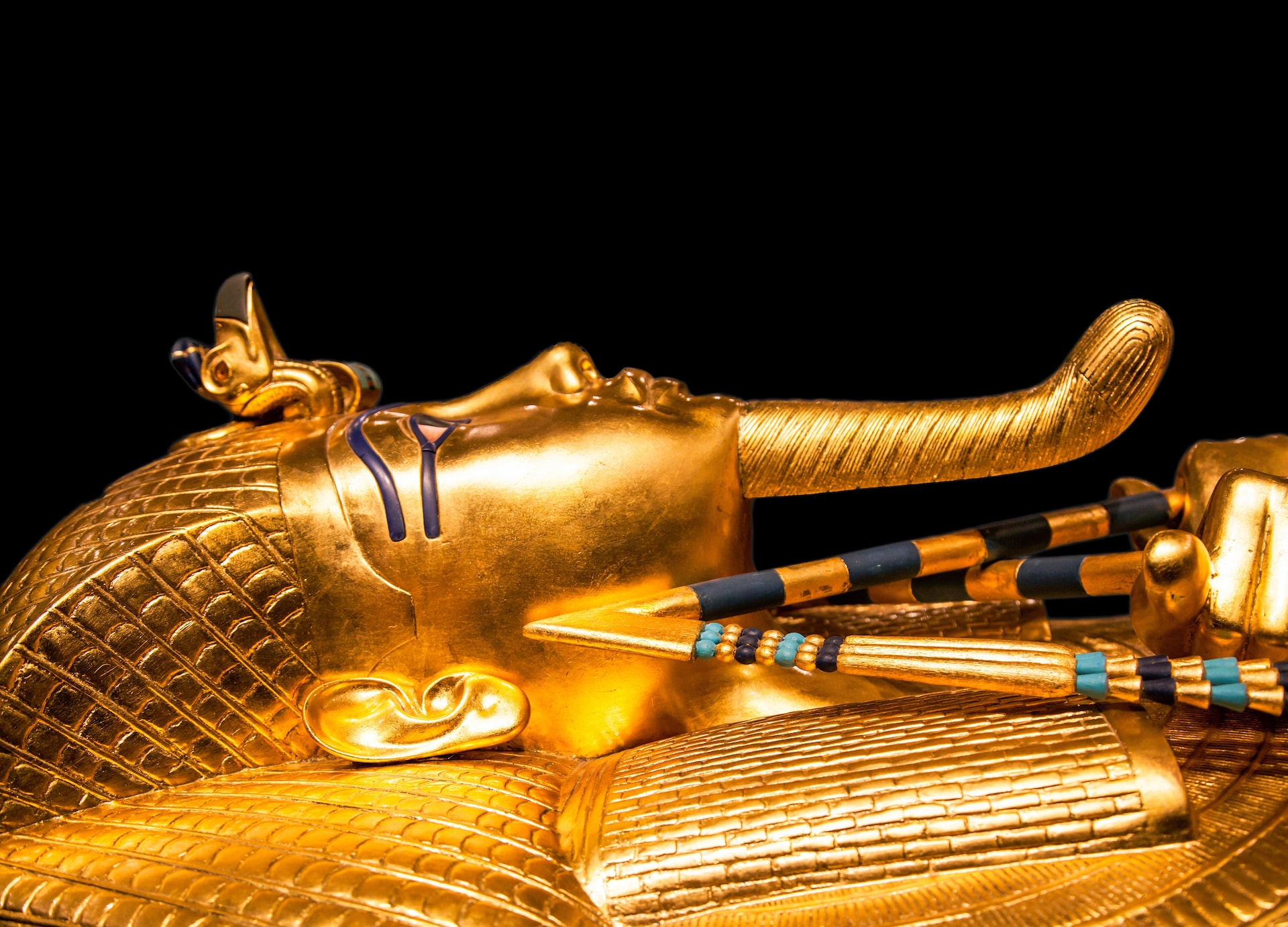 tutankhamuns golden burial mask on black