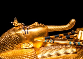 tutankhamuns golden burial mask on black