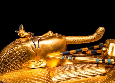 tutankhamuns golden burial mask on black