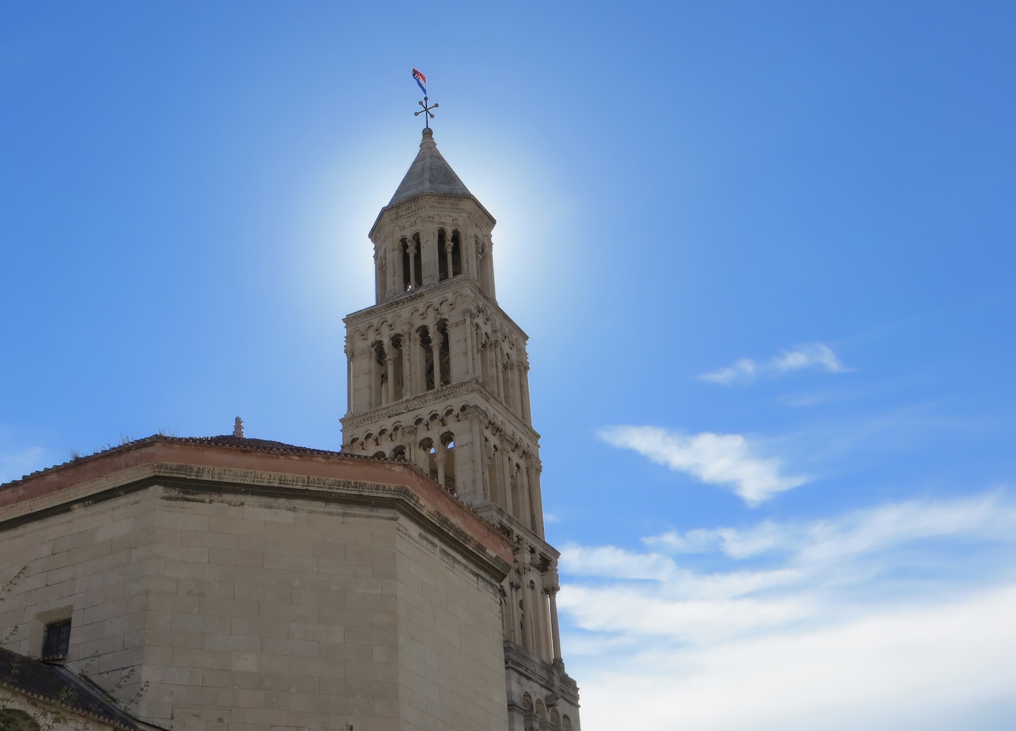 Saint Domnius Cathedral’s bell tower rises above Split’s old stone buildings under a clear sky. - Split, Croatia
