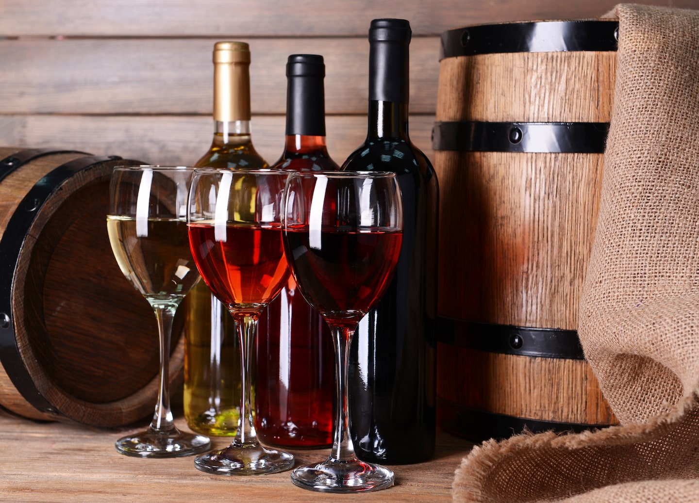 Various wine bottles and glasses displayed on wooden surface. - Cephalonia, Greece