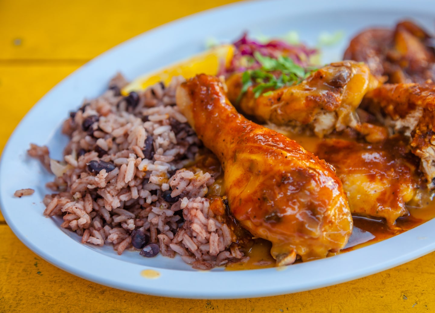 Grand Cayman’s jerk chicken features smoky, spicy flavors from scotch bonnet, thyme, and allspice marinade. - George Town, Grand Cayman