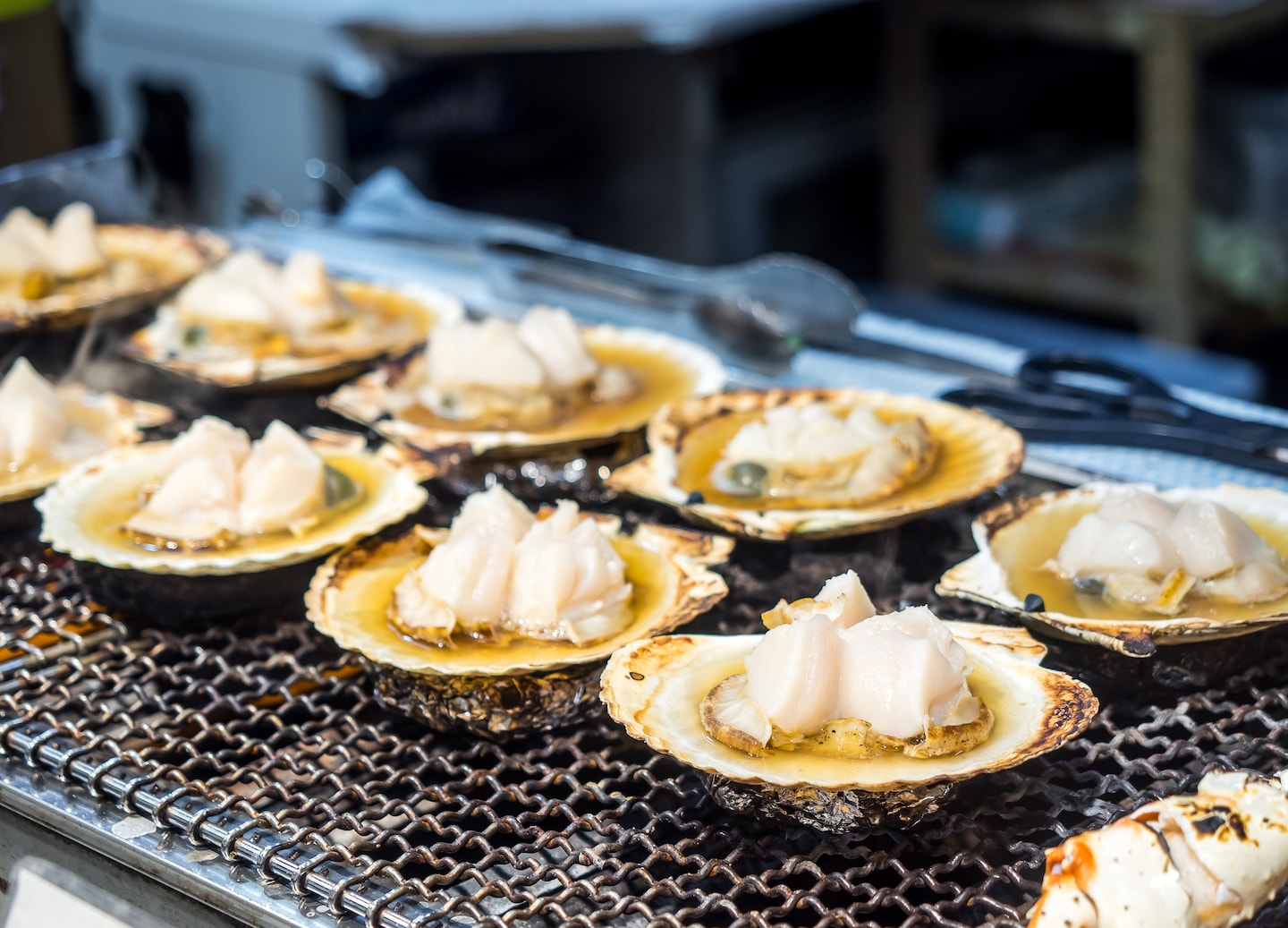 Fresh scallops sizzle on the grill, showcasing Hakodate’s famous morning market.. - Hakodate, Japan