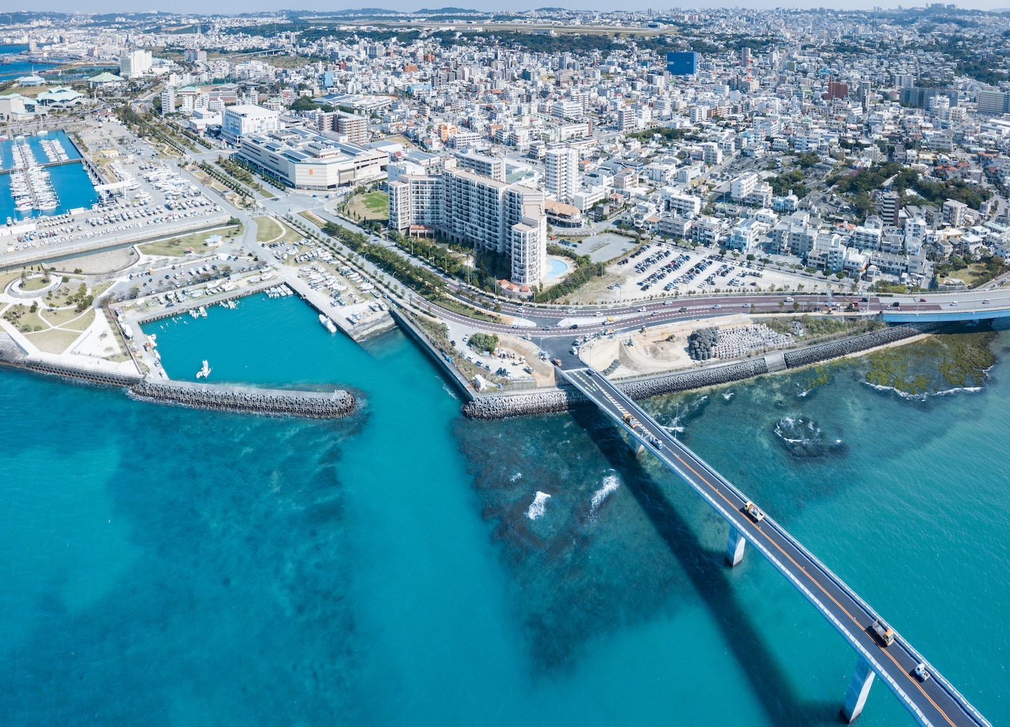 Okinawa’s cityscape stretches toward turquoise coastline. - Okinawa, Japan