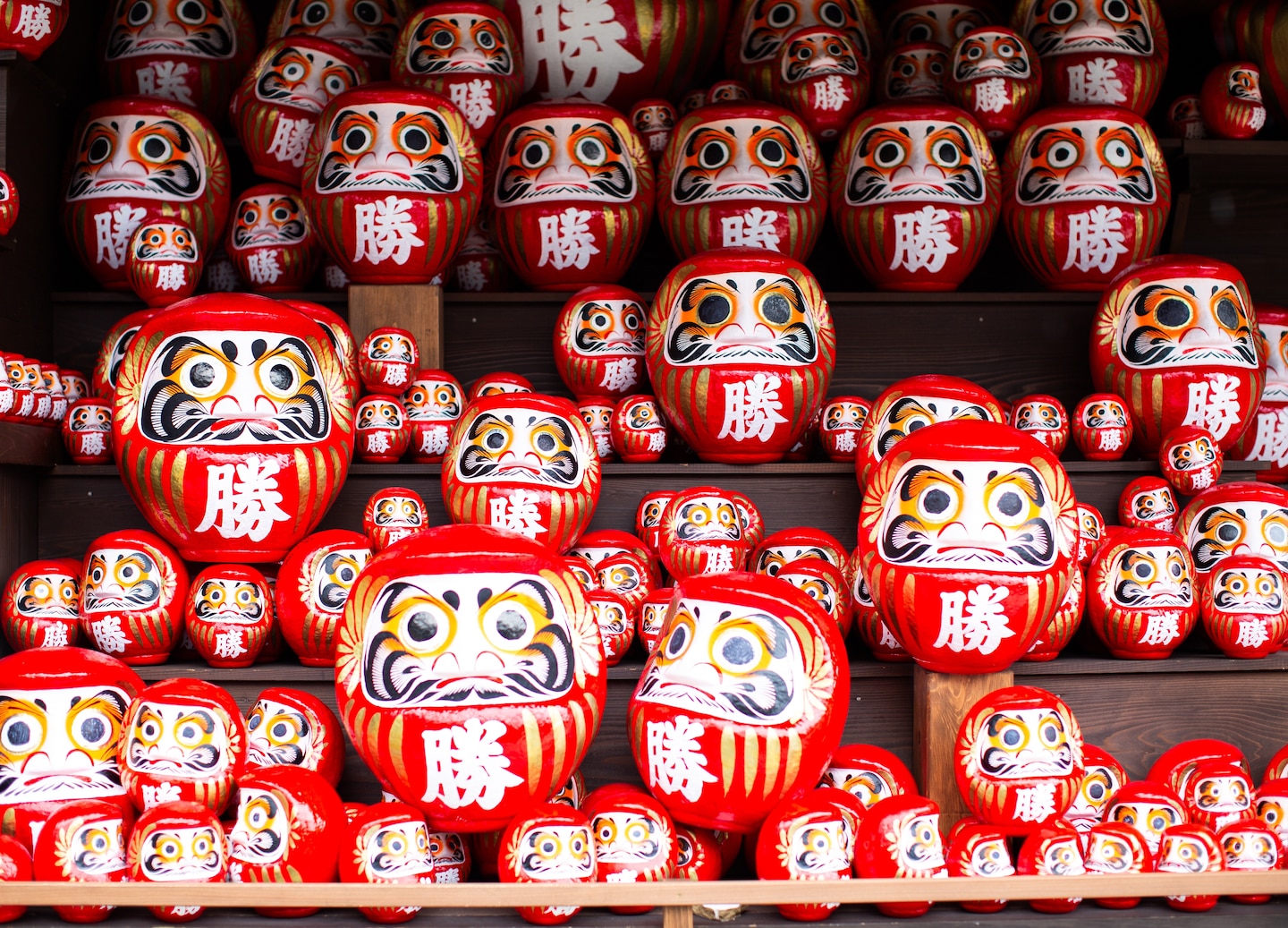 Rows of small daruma dolls fill Katsuoji Temple, symbolizing wishes and perseverance in bright colors. - Osaka, Japan 