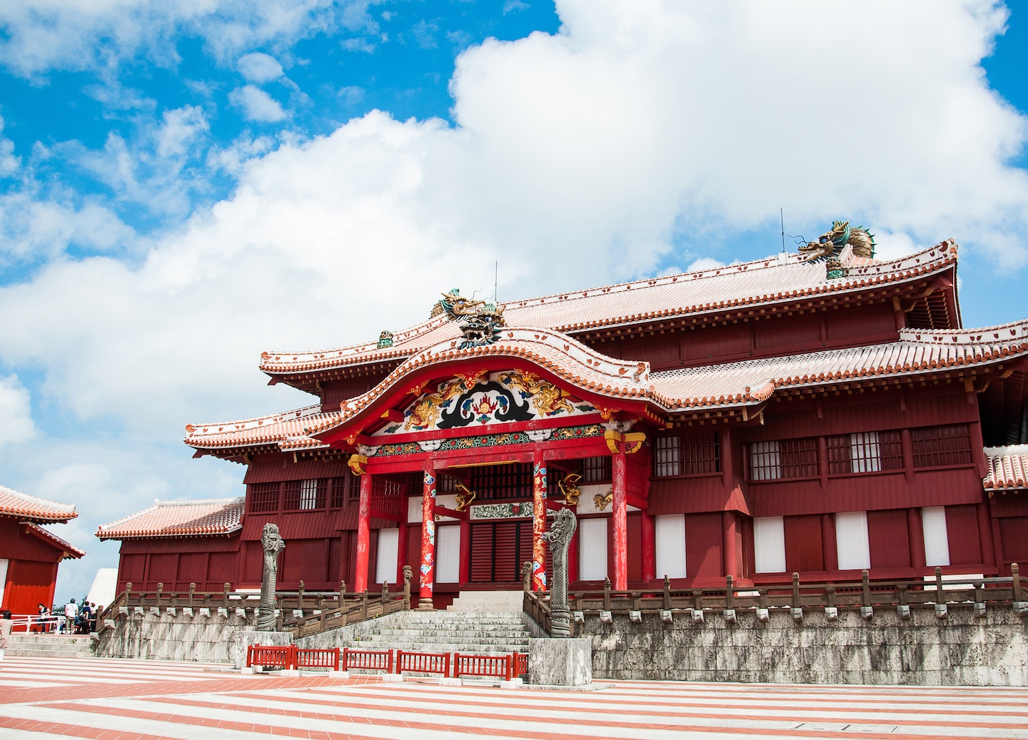 Shuri Castle’s vibrant red halls stand proudly above Okinawa’s surrounding cityscape. - Okinawa, Japan
