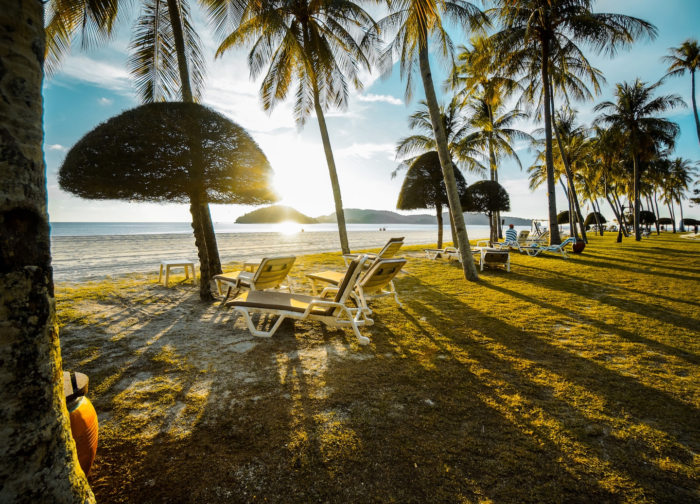 Sunset colors reflect across Cenang Beach as gentle waves roll toward Langkawi’s quiet shoreline. - Malaysia