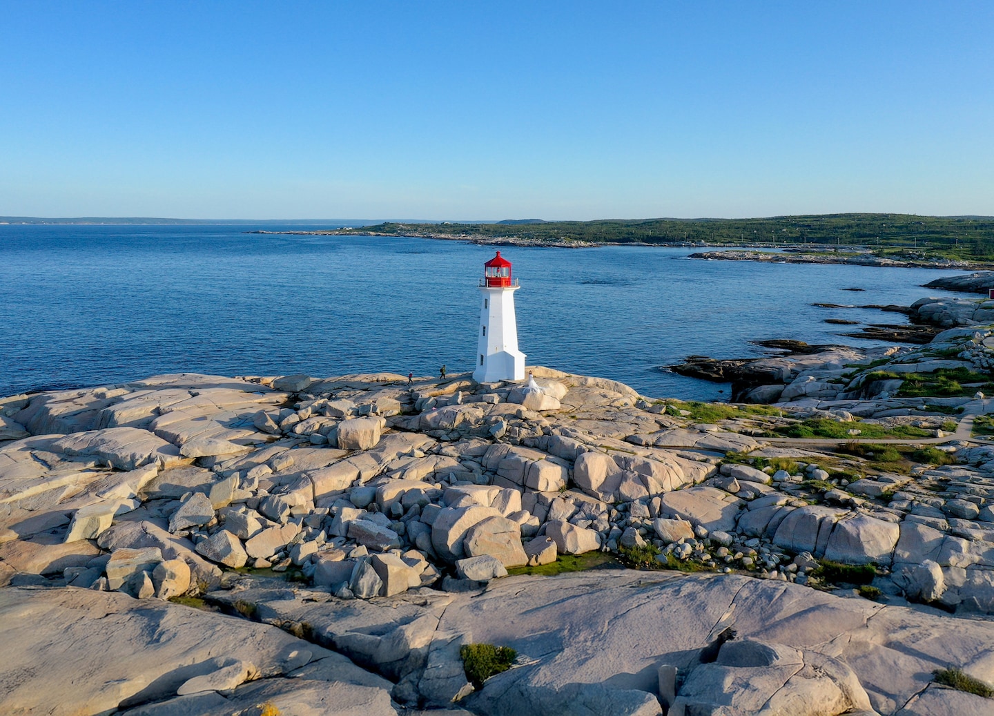 Peggy’s Cove Lighthouse stands on smooth granite rocks above the Atlantic’s crashing waves. - Halifax, Nova Scotia