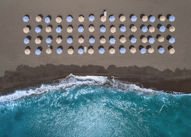royal beach club santorini aerial top down beach umbrellas