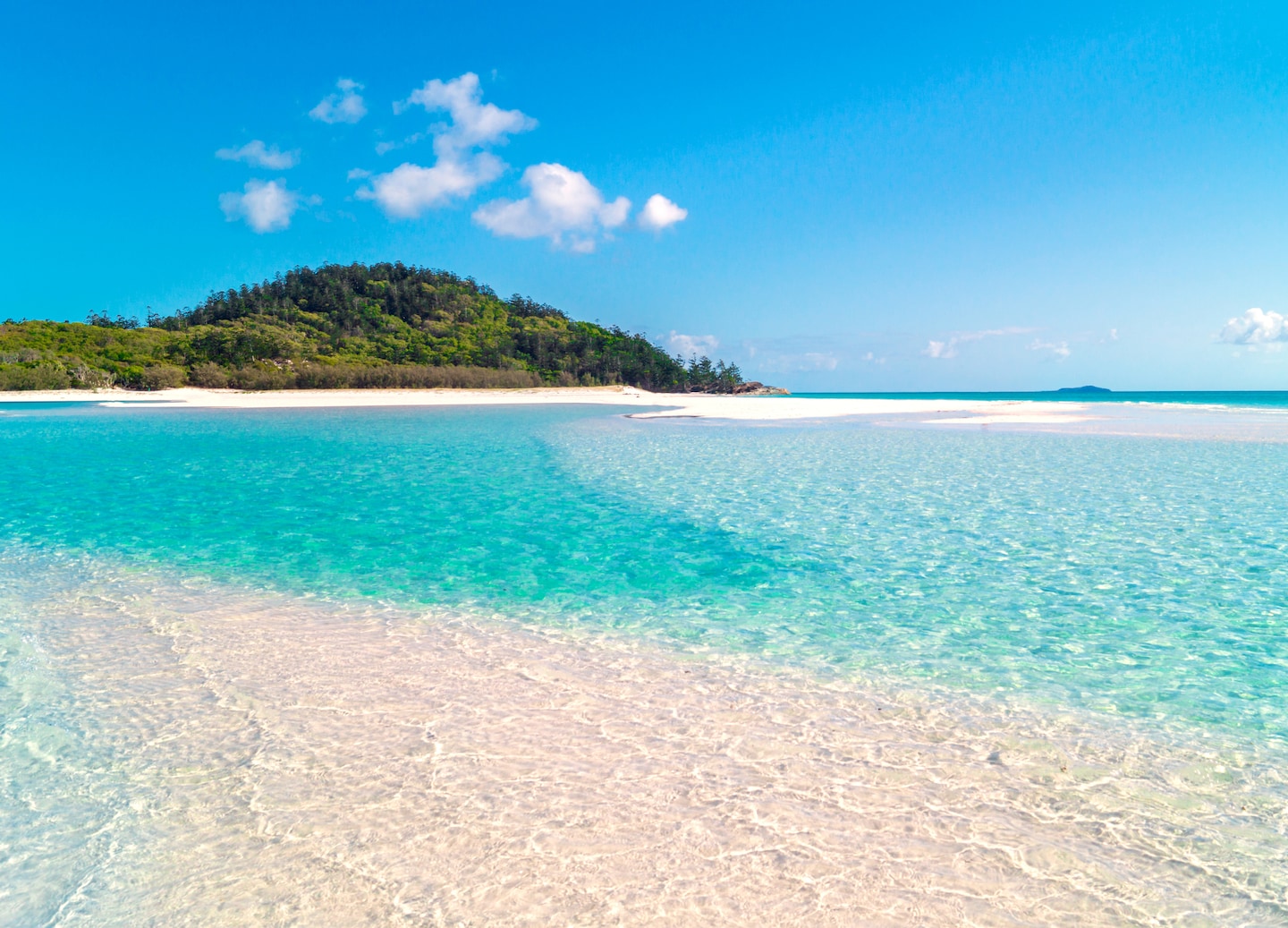 Whitehaven Beach's pristine white sands curve beside crystal-clear turquoise waters. - Airlie Beach, Queensland
