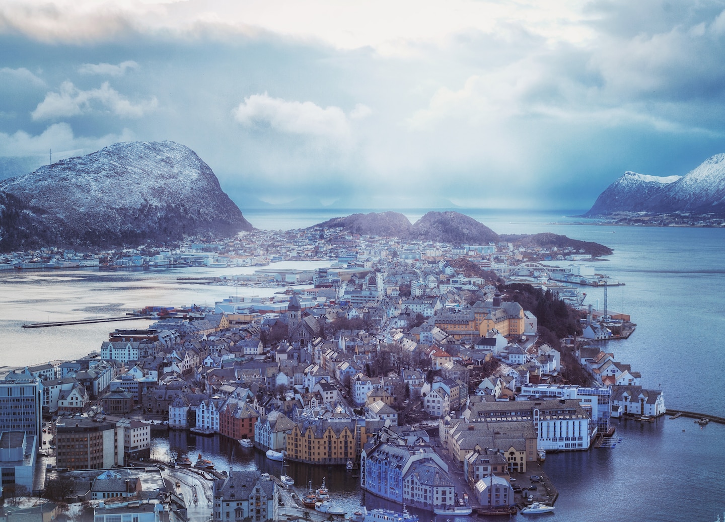 Winter in Ålesund brings snowy streets, northern lights, cozy cafés, museums, and nearby fjord skiing adventures. - Ålesund, Norway